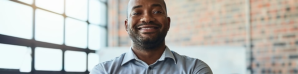  Cropped shot of a businessman standing in the office with his arms folded looking confident and smiling at the camera